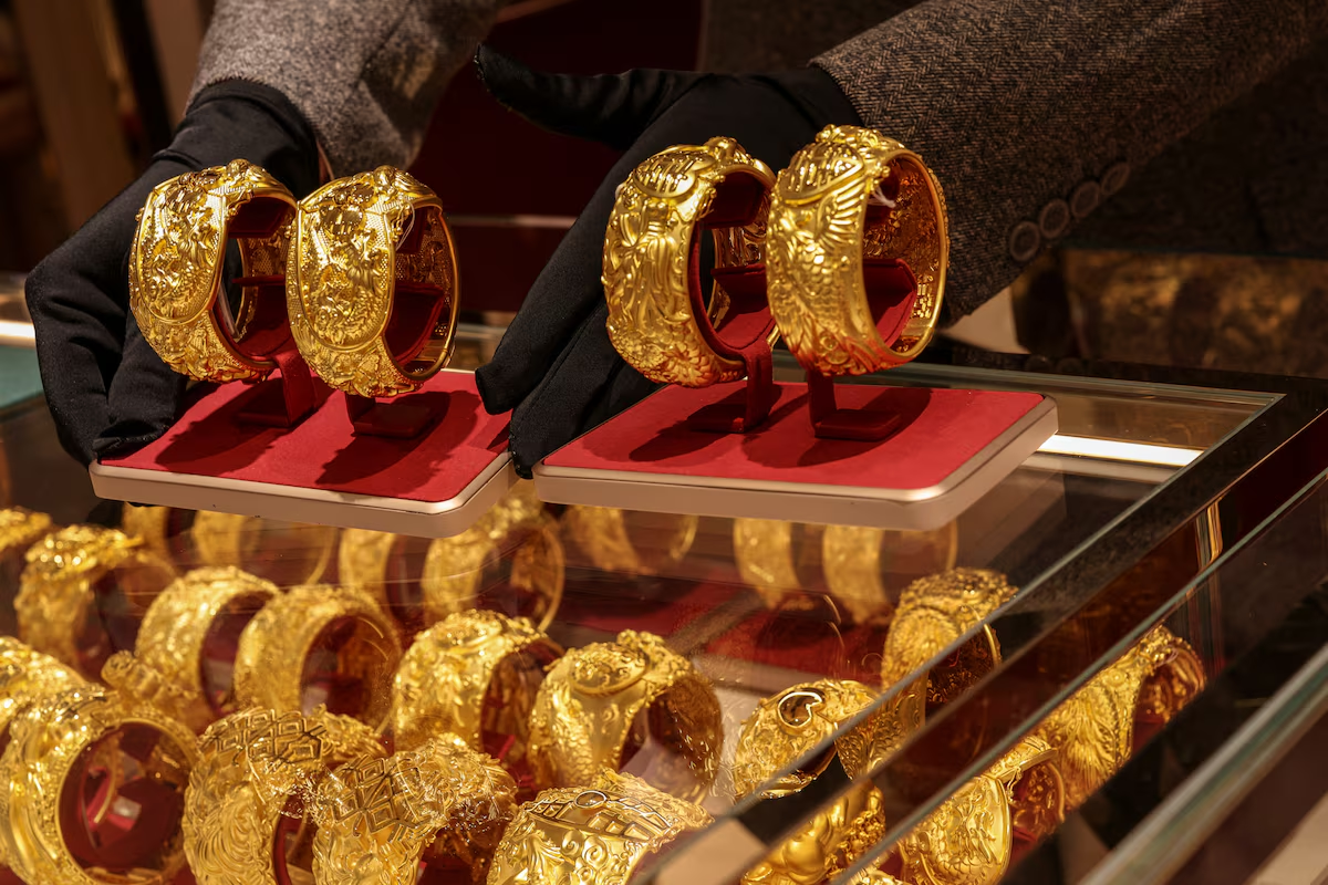Gold slips as firm dollar weighs; focus turns to Fed meeting